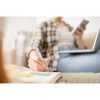 Close-up,Of,Unrecognizable,Woman,Sitting,On,Sofa,And,Making,Notes